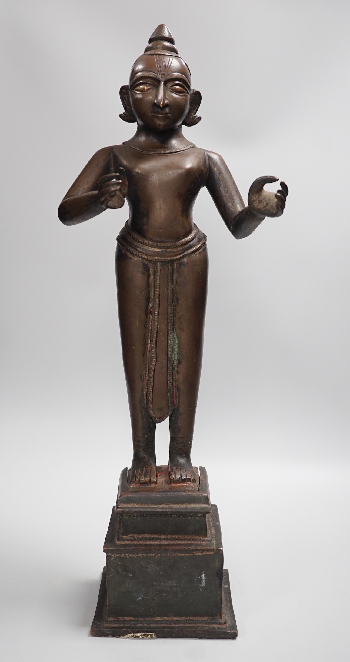 A large and heavy 19th century Indian bronze figure of Radha with separate bronze pedestal, total height 56cm